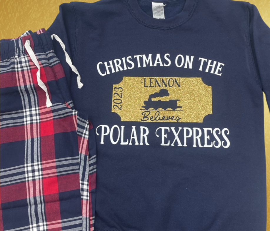 Experience the holiday spirit in style with these customisable Christmas
family matching pyjamas sets inspired by the Polar Express! Made with
100% cotton, these adorable matching sets in tartan with a navy blue short
sleeved t shirt is ideal for cozy family
nights or for that special polar express train ride. They even come with a
personalised gold glitter Polar Express ticket design on the top, featuring
your name and year for that extra special touch.