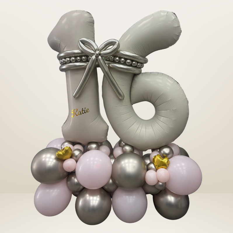 Age 16 themed balloon marquee/stack with balloon bow and balloon beads on a silver and pink balloon base.