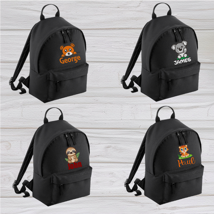 Introducing the fabulously fashionable, petite-sized Personalised Mini School Backpack! It's got it all: a nifty zippered front pocket, extra-cushy back panel and adjustable shoulder straps, plus a handy grab handle to boot!  Colour - Black Rucksack Dimensions - 24 x 33 x 17cm. Capacity 9 litres.  Choose between 4 colours - Jet Black, Jungle Camo, Navy Blue, Pretty in Pink!  Personalisation comes complimentary - no extra cost!