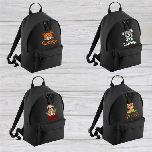 Introducing the fabulously fashionable, petite-sized Personalised Mini School Backpack! It's got it all: a nifty zippered front pocket, extra-cushy back panel and adjustable shoulder straps, plus a handy grab handle to boot!  Colour - Black Rucksack Dimensions - 24 x 33 x 17cm. Capacity 9 litres.  Choose between 4 colours - Jet Black, Jungle Camo, Navy Blue, Pretty in Pink!  Personalisation comes complimentary - no extra cost!