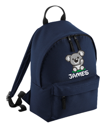 Introducing the fabulously fashionable, petite-sized Personalised Mini School Backpack! It's got it all: a nifty zippered front pocket, extra-cushy back panel and adjustable shoulder straps, plus a handy grab handle to boot!  Colour - Navy Blue Rucksack Dimensions - 24 x 33 x 17cm. Capacity 9 litres.  Choose between 4 colours - Jet Black, Jungle Camo, Navy Blue, Pretty in Pink!  Personalisation comes complimentary - no extra cost!
