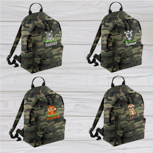 Introducing the fabulously fashionable, petite-sized Personalised Mini School Backpack! It's got it all: a nifty zippered front pocket, extra-cushy back panel and adjustable shoulder straps, plus a handy grab handle to boot!  Colour - Jungle Camo Rucksack Dimensions - 24 x 33 x 17cm. Capacity 9 litres.  Choose between 4 colours - Jet Black, Jungle Camo, Navy Blue, Pretty in Pink!  Personalisation comes complimentary - no extra cost!