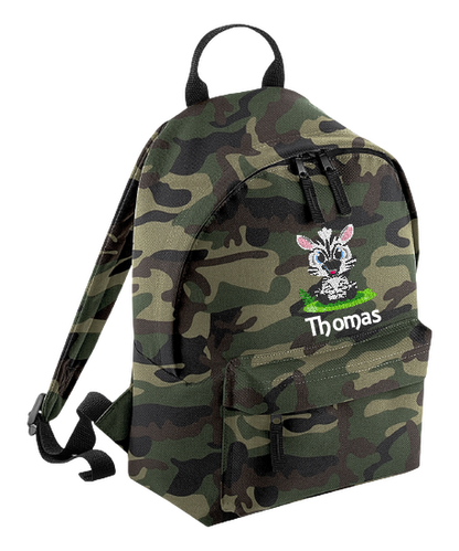 Introducing the fabulously fashionable, petite-sized Personalised Mini School Backpack! It's got it all: a nifty zippered front pocket, extra-cushy back panel and adjustable shoulder straps, plus a handy grab handle to boot!  Colour - Jungle Camo Rucksack Dimensions - 24 x 33 x 17cm. Capacity 9 litres.  Choose between 4 colours - Jet Black, Jungle Camo, Navy Blue, Pretty in Pink!  Personalisation comes complimentary - no extra cost!