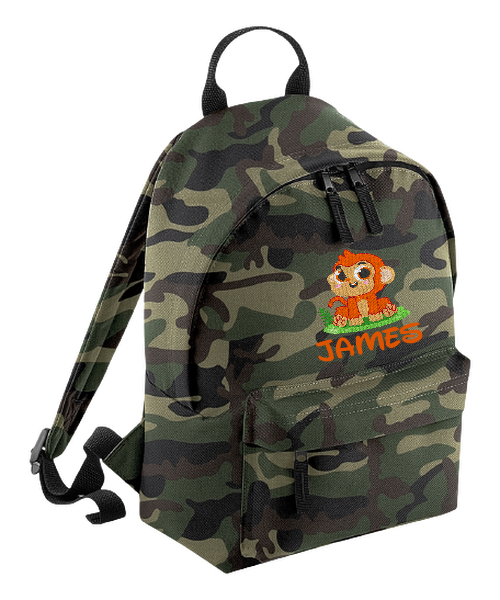 Introducing the fabulously fashionable, petite-sized Personalised Mini School Backpack! It's got it all: a nifty zippered front pocket, extra-cushy back panel and adjustable shoulder straps, plus a handy grab handle to boot!  Colour - Jungle Camo Rucksack Dimensions - 24 x 33 x 17cm. Capacity 9 litres.  Choose between 4 colours - Jet Black, Jungle Camo, Navy Blue, Pretty in Pink!  Personalisation comes complimentary - no extra cost!
