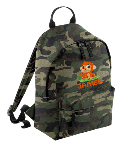 Introducing the fabulously fashionable, petite-sized Personalised Mini School Backpack! It's got it all: a nifty zippered front pocket, extra-cushy back panel and adjustable shoulder straps, plus a handy grab handle to boot!  Colour - Jungle Camo Rucksack Dimensions - 24 x 33 x 17cm. Capacity 9 litres.  Choose between 4 colours - Jet Black, Jungle Camo, Navy Blue, Pretty in Pink!  Personalisation comes complimentary - no extra cost!