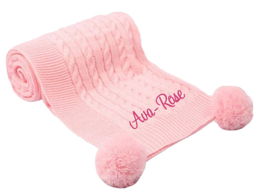 Treat a special little girl to the perfect gift! Our exclusive baby cable knitted pom pom blanket, in stunning Pink, is customised with her name and desired font style and colour. Soft and cuddly, it's ideal for any cot or pram and measures 70 x 100 cm. Make her feel extra special with a personalised embroidered baby pink cable knitted blanket!