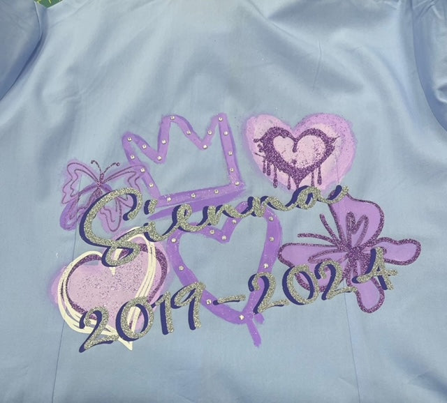 Personalised Glitter; Diamante School Leavers Signing Shirts Silver Glitter Lilac for Class Year 2025 Children.  A beautiful Keepsake of Memories from the Last Day Of School.  This listing offers a unique personalized glitter and diamante layered design with Diamanté Crown & Heart, Butterflies and Graffiti Hearts, complete with your name and leavers dates. Feel like royalty on your special day with the stunning crown, hearts, and butterflies designs. We offer a range of colour schemes for your shirt.