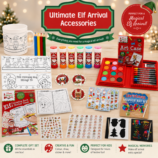 Ultimate Elf Arrival Accessories gift set arranged on a light wood surface with a festive blurred Christmas background. The set includes a white ceramic mug with holiday line art, colored pencils, paint tubes, an art case with watercolor paints, crayons, sticker sheets, coloring book pages, scratch art, black paint brushes, and other Christmas-themed accessories.