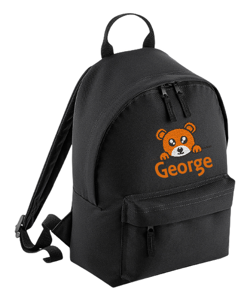 Introducing the fabulously fashionable, petite-sized Personalised Mini School Backpack! It's got it all: a nifty zippered front pocket, extra-cushy back panel and adjustable shoulder straps, plus a handy grab handle to boot!  Colour - Black Rucksack Dimensions - 24 x 33 x 17cm. Capacity 9 litres.  Choose between 4 colours - Jet Black, Jungle Camo, Navy Blue, Pretty in Pink!  Personalisation comes complimentary - no extra cost!