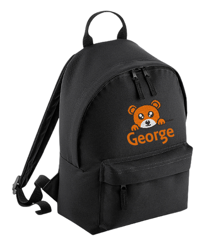 Introducing the fabulously fashionable, petite-sized Personalised Mini School Backpack! It's got it all: a nifty zippered front pocket, extra-cushy back panel and adjustable shoulder straps, plus a handy grab handle to boot!  Colour - Black Rucksack Dimensions - 24 x 33 x 17cm. Capacity 9 litres.  Choose between 4 colours - Jet Black, Jungle Camo, Navy Blue, Pretty in Pink!  Personalisation comes complimentary - no extra cost!