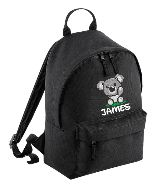 Introducing the fabulously fashionable, petite-sized Personalised Mini School Backpack! It's got it all: a nifty zippered front pocket, extra-cushy back panel and adjustable shoulder straps, plus a handy grab handle to boot!  Colour - Black Rucksack Dimensions - 24 x 33 x 17cm. Capacity 9 litres.  Choose between 4 colours - Jet Black, Jungle Camo, Navy Blue, Pretty in Pink!  Personalisation comes complimentary - no extra cost!