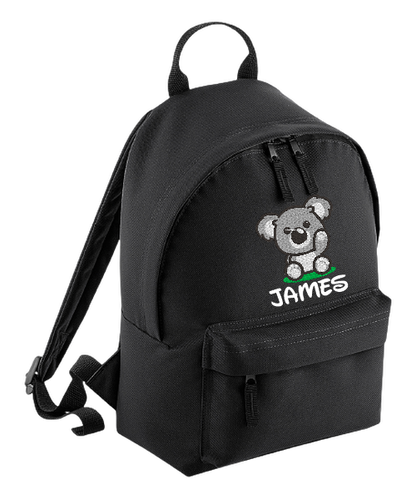 Introducing the fabulously fashionable, petite-sized Personalised Mini School Backpack! It's got it all: a nifty zippered front pocket, extra-cushy back panel and adjustable shoulder straps, plus a handy grab handle to boot!  Colour - Black Rucksack Dimensions - 24 x 33 x 17cm. Capacity 9 litres.  Choose between 4 colours - Jet Black, Jungle Camo, Navy Blue, Pretty in Pink!  Personalisation comes complimentary - no extra cost!