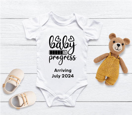 Capture your pregnancy announcement with this adorable personalised Baby in Progress baby grow! Personalised with Arrival Month; Year. Inform all your family, friends and even the world in the best way possible with a personalised short sleeved bodysuit. Share your excitement on social media platforms with the unique touch of a custom baby bodysuit. It also makes for the perfect baby shower gift.