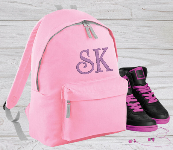 Our personalised Junior Pink School Rucksack Backpack has got it all: a zippered front pocket, comfy padded back panel, adjustable straps for extra support and a handy grab handle. Enjoy your schooldays in style! Going back to school with you very own personalised school bag.  Colour - Pink Rucksack Dimensions 28 x 38 x 19cm. Capacity 12 litres.   (Other colours Burgundy, French Navy, Black, Jungle Camo, Navy Blue, Fuchsia Pink, Purple, Red, Royal Blue, and Surf Blue - take your pick!)