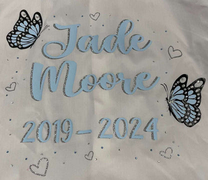 Custom Class of 2026 glitter and diamanté baby blue butterfly signing shirt with glitter silver hearts, personalized name and dates.