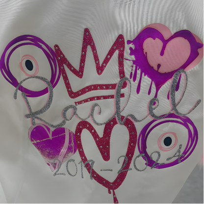 Decorative leavers shirt with glitter text and heart designs. Includes evil eyes,, crown design.