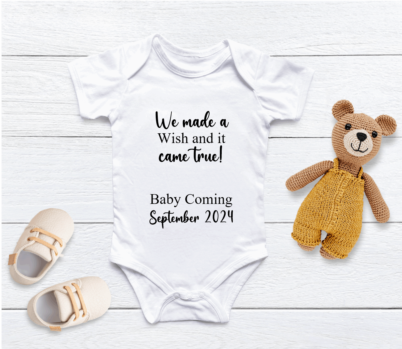 Capture your pregnancy announcement with this adorable personalised We Made A Wish baby grow! Personalised with Arrival Month &amp; Year. Inform all your family, friends and even the world in the best way possible with a personalised short sleeved bodysuit. Share your excitement on social media platforms with the unique touch of a custom baby bodysuit. It also makes for the perfect baby shower gift.