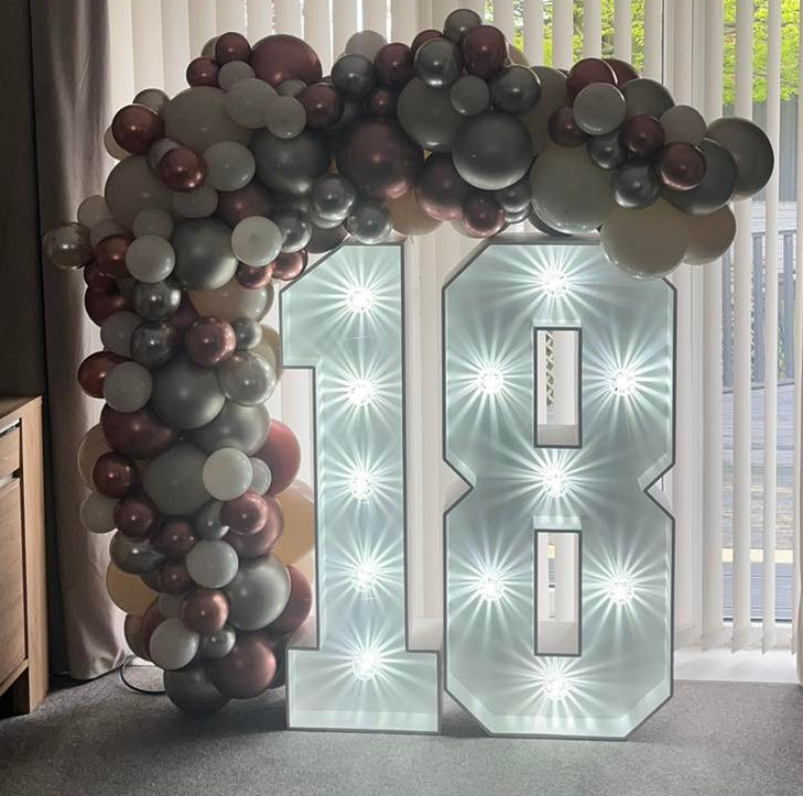Organic balloons arch around light up numbers for a 18th Birthday