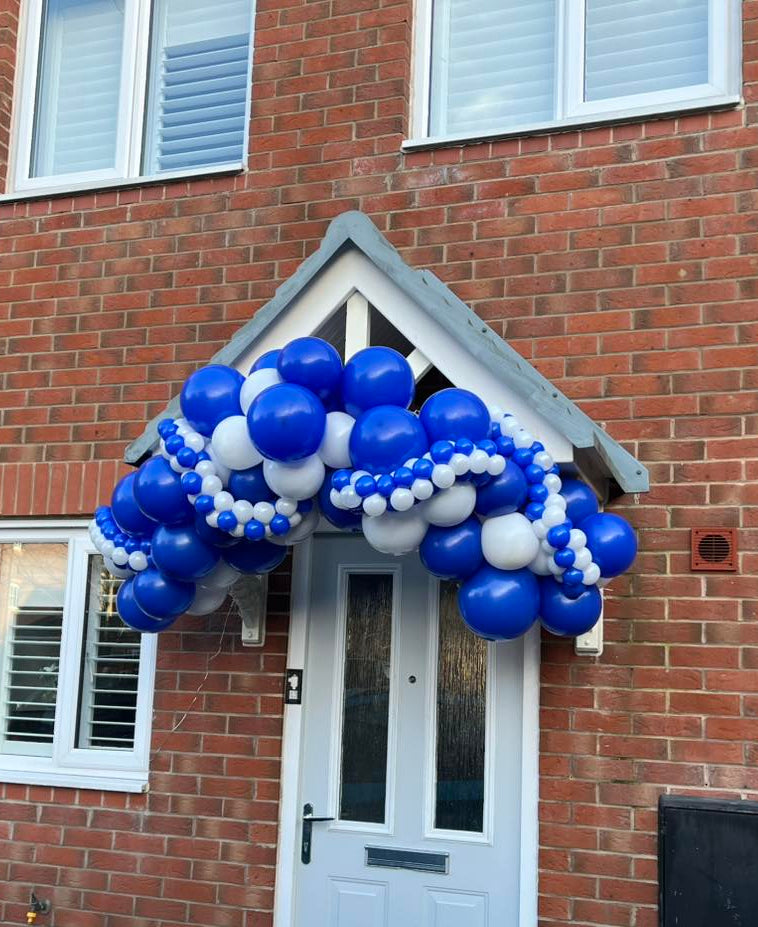 Organic balloon arch attached to a front door canopy entrance