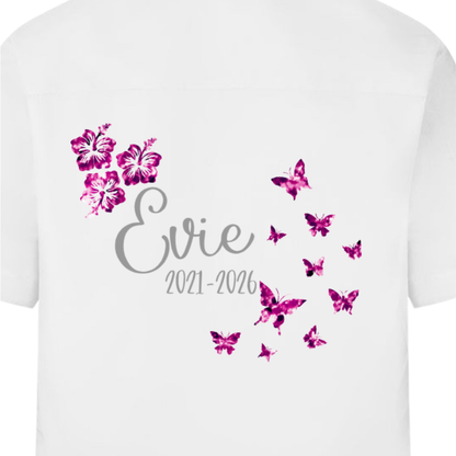 White leavers signing shirt with glitter pink butterflies and hibiscus flowers. The name and start and leavers yearsalso appear